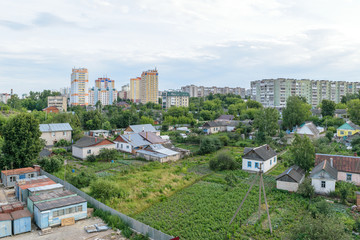 Obraz premium Garden plots and orchards near the multi-storey residential buildings