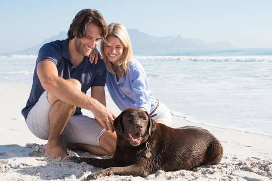 Couple Playing With Dog