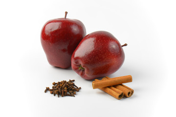 red apples, cinnamon sticks and dried cloves