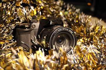 Christmas and new year's tinsel and a camera