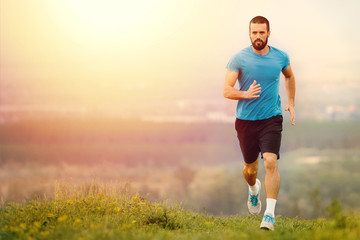 Athletic young man running in the nature. Healthy lifestyle

