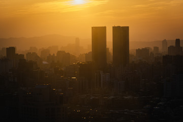 Fototapeta premium View of buildings in haze at sunset, from Elephant Mountain, in