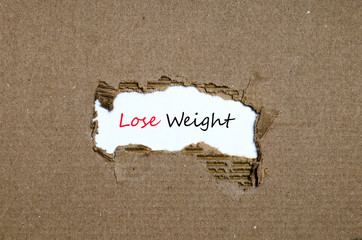 The word lose weight appearing behind torn paper