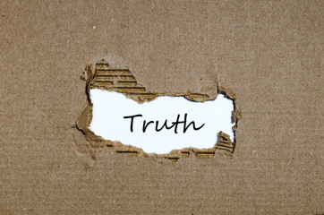 The word truth appearing behind torn paper