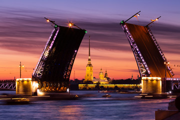 Fototapeta na wymiar Open Palace Bridge and view of the Peter and Paul Fortress in St.Petersburg in white night