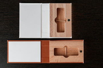 Packaging for USB drives. Box with -stick photographer. Wooden boxes on dark background