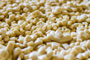 Lots of dough pieces. Raw pastry of light color. Prepare decoration for wedding bread. Heat up the oven.