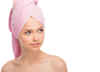 Face of a beautiful young woman with a towel