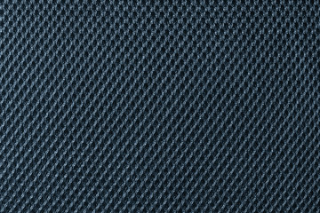 Deep blue fishnet cloth material as a texture background. Nylon texture pattern or nylon background for design with copy space for text or image.