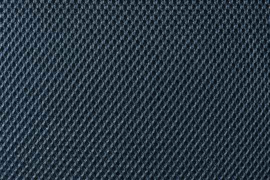 Deep blue fishnet cloth material as a texture background. Nylon texture pattern or nylon background for design with copy space for text or image.