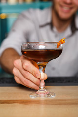 Bartender offers alcohol cocktail in night club bar