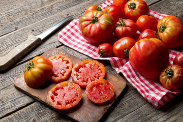 Dojrzałe organiczne pomidory na drewnianym tle