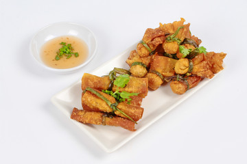 Gold bar and gold bag ,Deep fried Chinese sheet wrap minced pork by shallot,served with sweet sauce on white background. Side view
