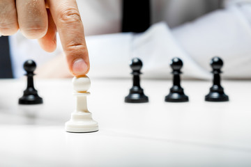 Hand of businessman playing chess