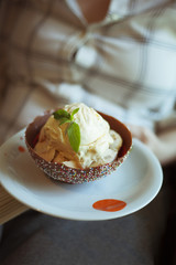 Vanilla ice cream in a bowl made of chocolate