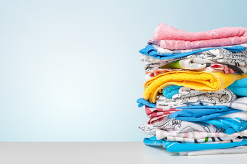 Stack of bath towels on light white background closeup