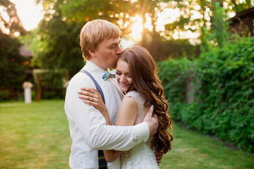 Fototapeta premium Sweet and lovely hugs of happy wedding couple