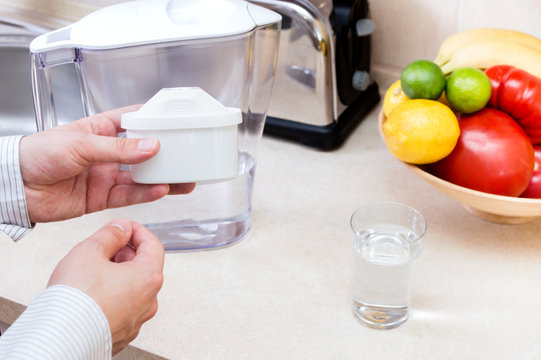 Man Changes Filter In The Filter Jug