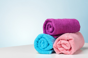 Obraz na płótnie Canvas Stack of bath towels on white desk closeup
