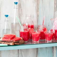 Watermelon drink in glasses with slices of watermelon mint and lemon,