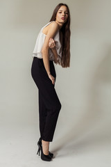Fototapeta premium Full length portrait of a beautiful smiling woman posing isolated