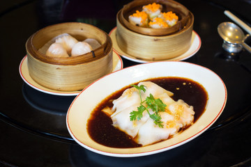 Spring rolls with sweet sauce and dumplings on the table
