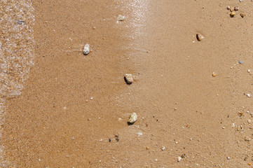 Sea pebble stone and sand texture background