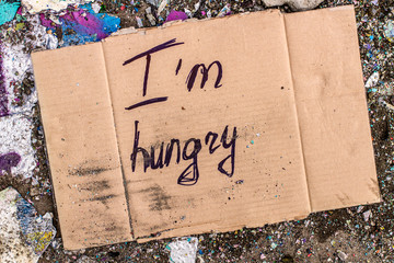 Sign of homeless man on cardboard