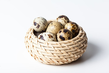 Naklejka na ściany i meble Fresh quail eggs at wooden plate closeup