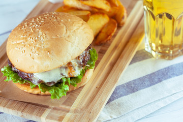 burger and french fries on wooden table