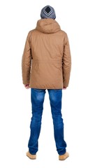 Back view of handsome man in winter jacket  looking up.   Standing young guy in parka. Rear view people collection.  backside view of person.  Isolated over white background.