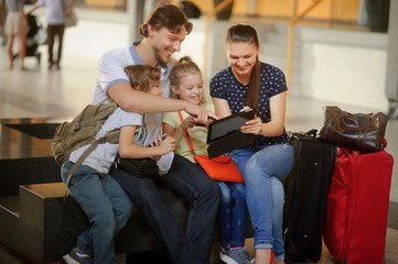 Parents with two children at the railway station.