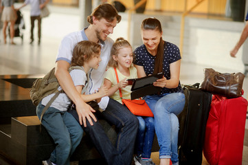 Parents with two children at the railway station.