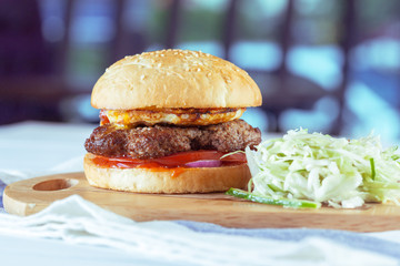 home made burgers on wooden background