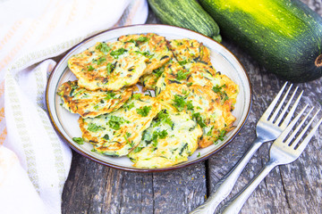 Squash and zucchini fritters on old wooden table