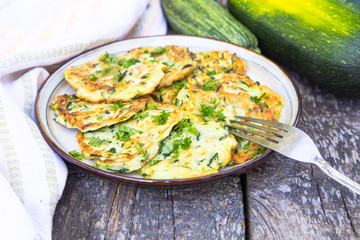 Squash and zucchini fritters on old wooden table