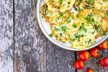 Squash and zucchini fritters on old wooden table