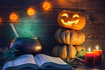Fototapeta premium pumpkin, candles, spell book and potion