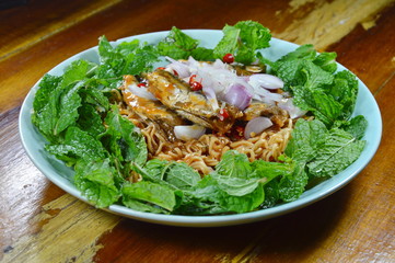 spicy instant noodle with fish canned salad on plate