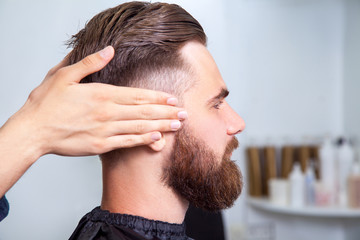 Bearded man sitting in the barbershop © khosrork