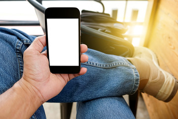 Man playing smart mobile phones with .Leg Jeans background.