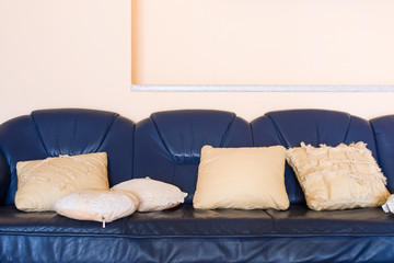 Pillows on the leather blue sofa