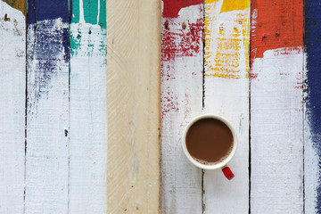 coffee cup on grunge wooden panel background.