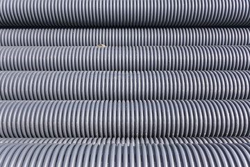 Closeup of black plastic pipes with diminishing perspective