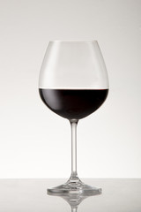 Bordeaux style red wine glass with red wine.