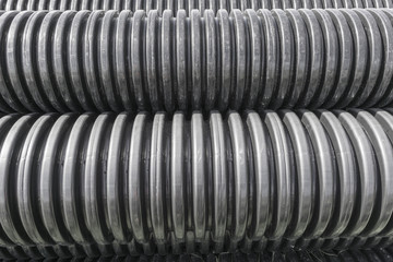 Closeup of black plastic pipes with diminishing perspective - different focus