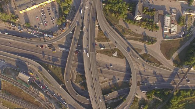 Aerial footage of highway and overpass with cars and trucks, Kiev,Ukraine. Smooth video from drone roadway interchange in several levels at sunset. 4k video. Aerial view. Top view.