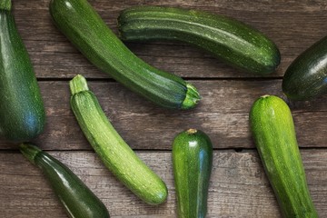 Fresh organic zucchini on the wooden table