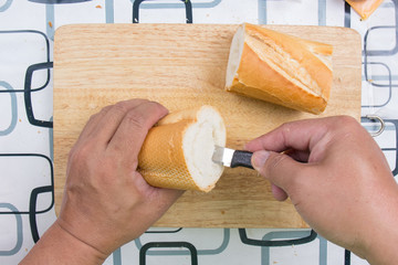 Hand with knife penetrate bread