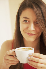 Coffee. Beautiful Girl Drinking Coffee in Cafe. Beauty Model Wom